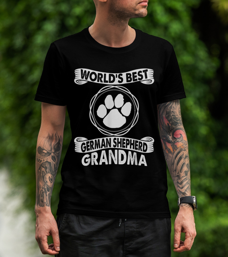 Man with tattoos models World's Best German Shepherd Grandma Paw Prints T-Shirt outdoors.