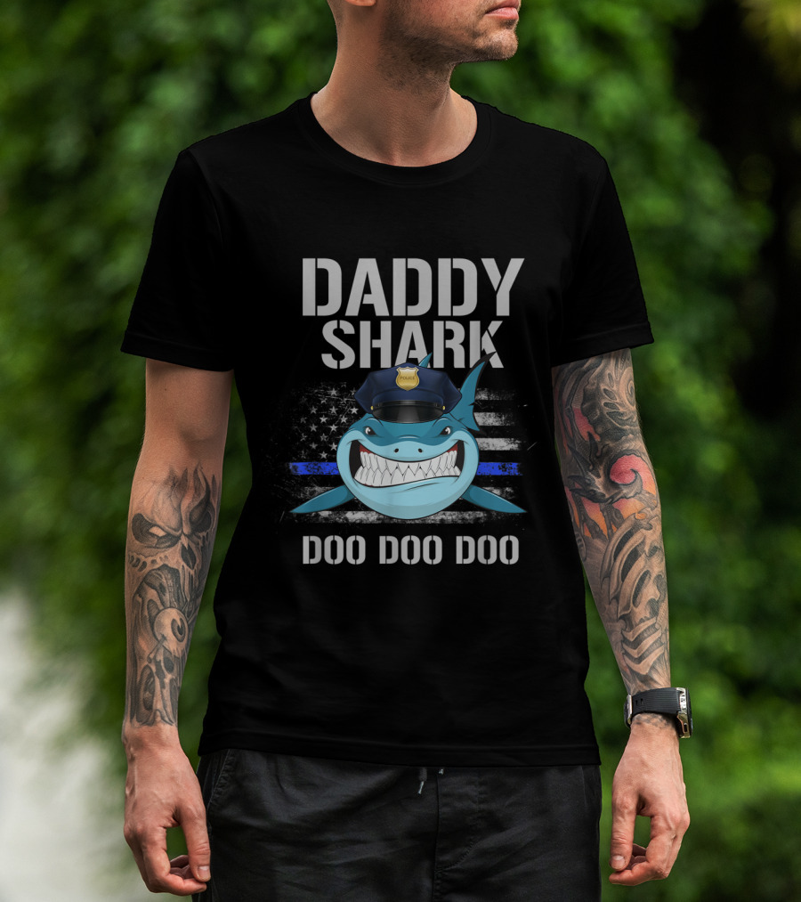 Man with tattoos models Daddy Shark Thin Blue Line Flag Police Doo Doo Doo T-Shirt outdoors.