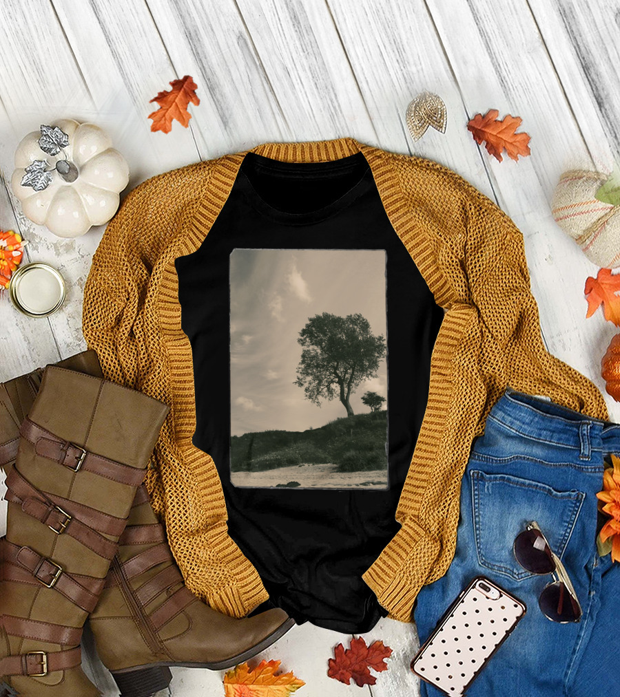 Tree on Grassy Hillside Under Cloudy Sky T-Shirt