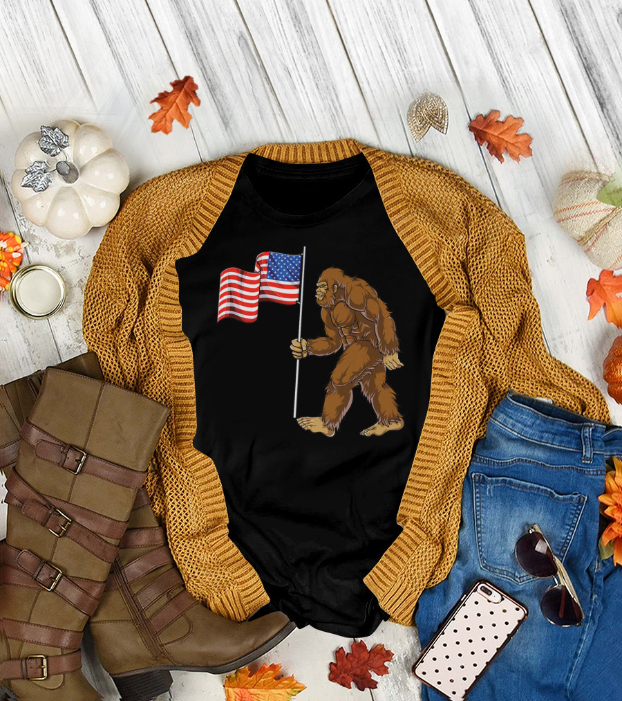 Bigfoot Carrying American Flag 4th of July Sasquatch T-Shirt