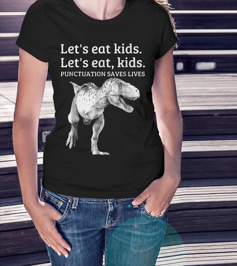 Woman with hands in pockets wearing Let's Eat Kids Let's Eat Kids Punctuation Saves Lives Dinosaur T-Shirt.