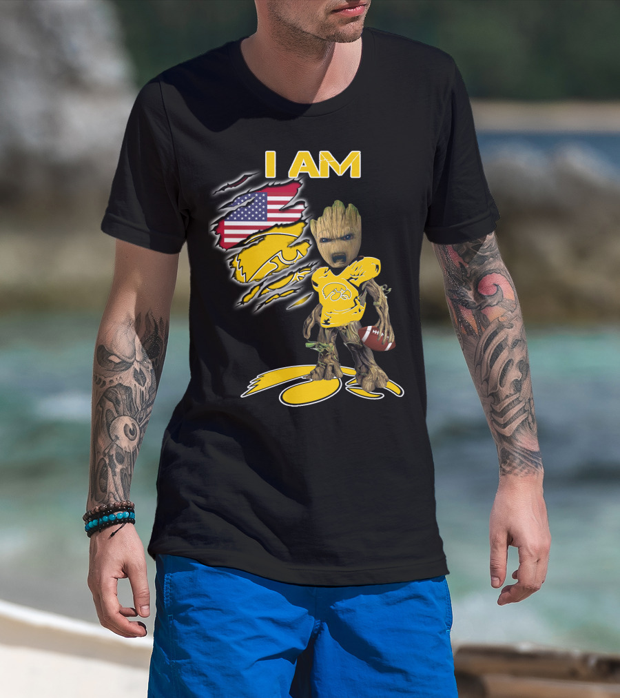 I Am Hawkeyes Baby Groot Holding Football With Usa Flag And Iowa Hawkeyes T-Shirt