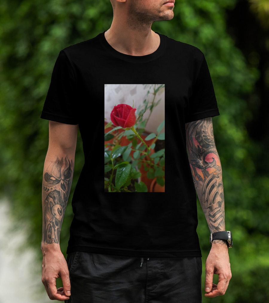 Man with tattoos models Rosse Red Rose Bloom with Green Leaves in Natural Setting T-Shirt outdoors.