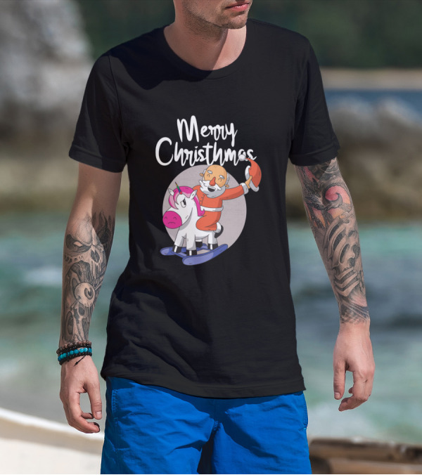 Man with tattoos models Merry Christmas Santa Riding Unicorn T-Shirt at beach.