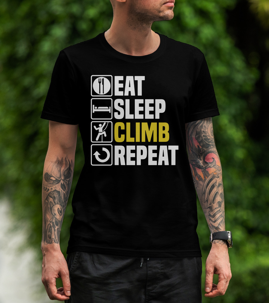 Man with tattoos models Eat Sleep Climb Repeat T-Shirt outdoors.