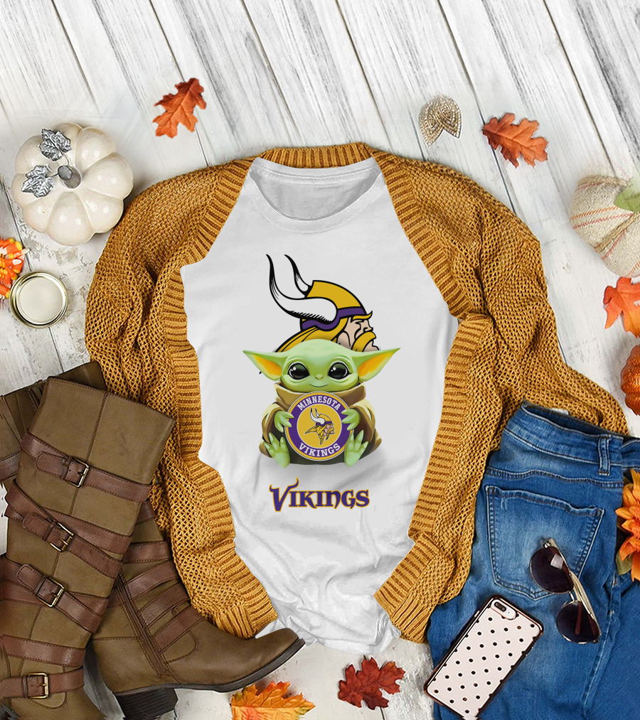 Grogu Holding Minnesota Vikings Symbol with Viking Helmet Background T-Shirt