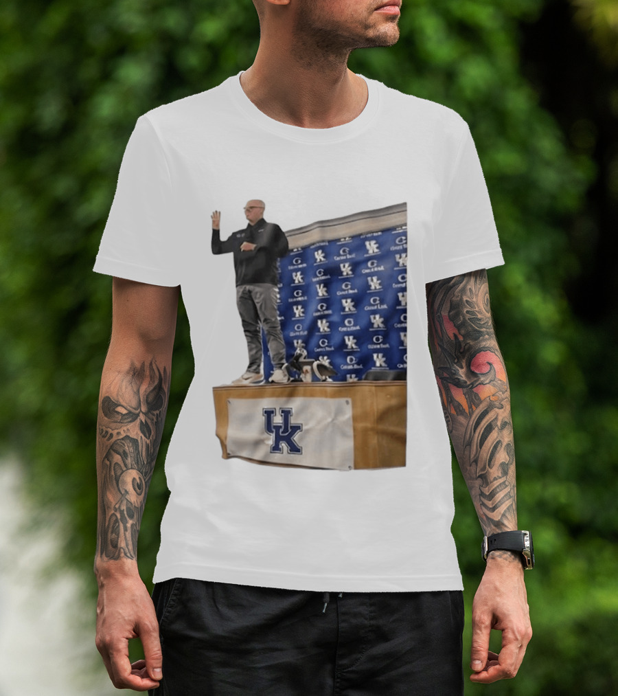 UK Volleyball Coach Craig Skinner Standing On Table With UK Logo And Awards T-Shirt