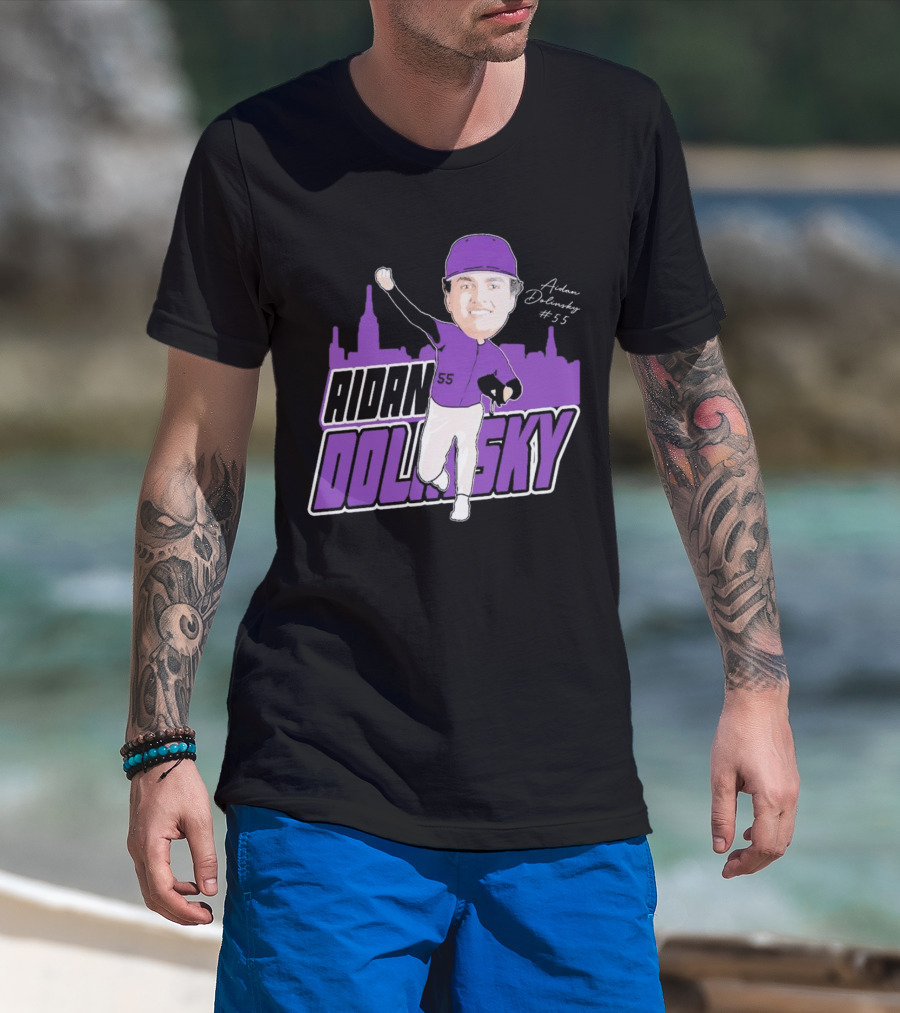 Man with tattoos models Aidan Dolinsky #55 NYU Baseball Purple City Skyline Signature T-Shirt at beach.