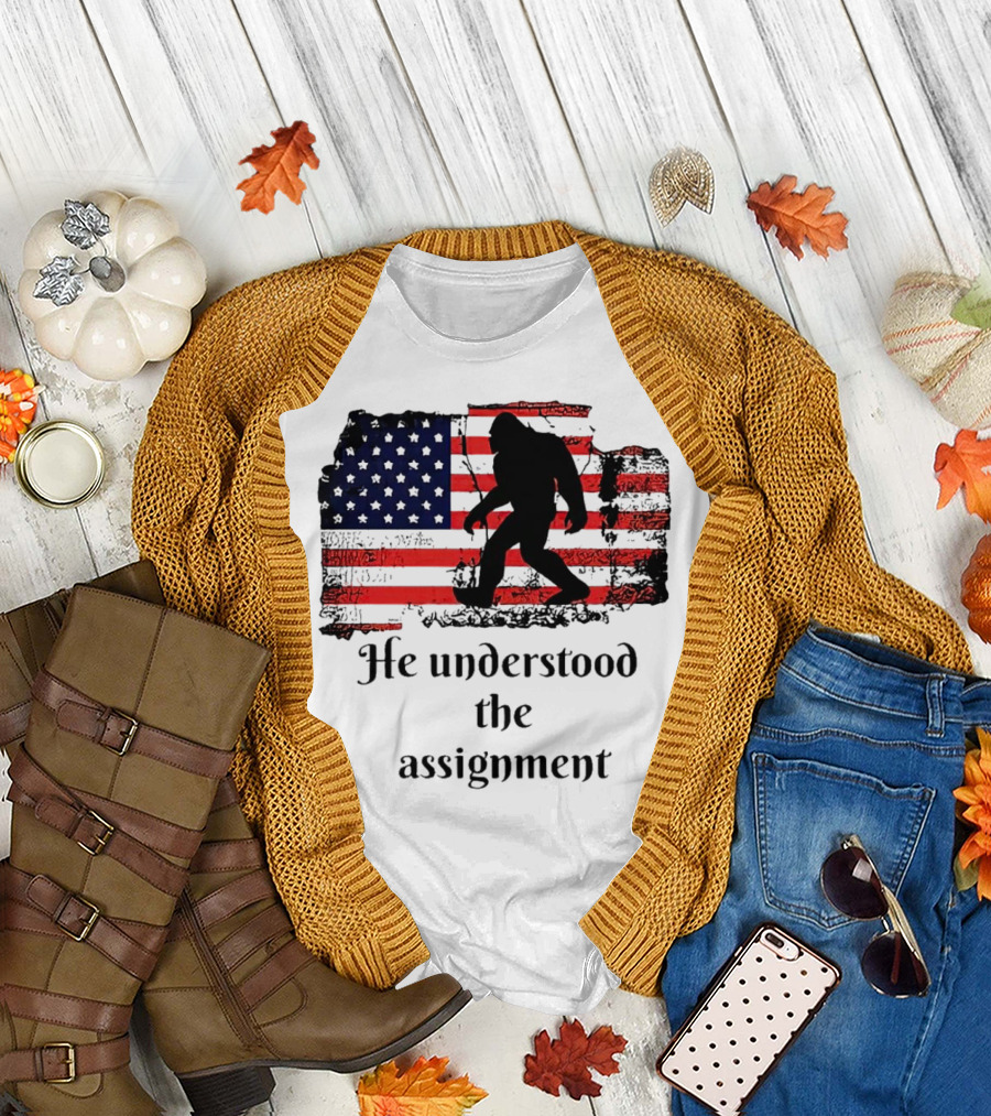 Bigfoot Silhouette with Distressed American Flag He Understood the Assignment T-Shirt