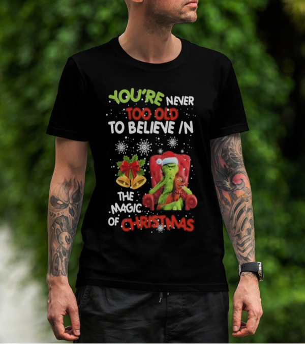 YOU'RE NEVER TOO OLD TO BELIEVE IN THE MAGIC OF CHRISTMAS GRINCH WITH MAX SITTING IN CHAIR SNOWFLAKES HOLIDAY BELLS AND BOW T-Shirt
