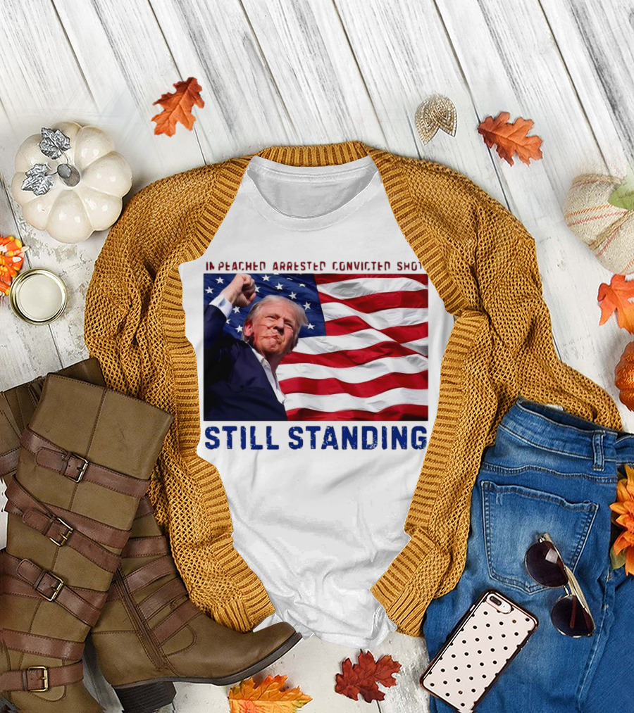 Still Standing Trump Impeached Arrested Convicted Shot American Flag Background T-Shirt