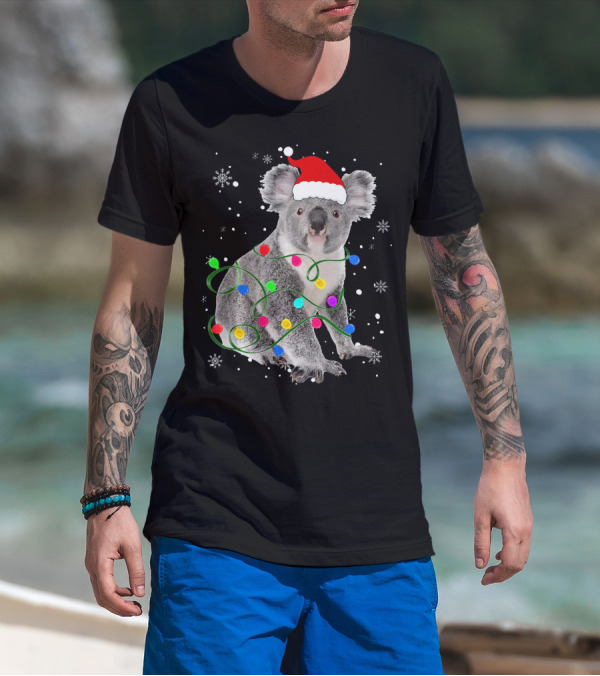 Koala Wrapped In Christmas Lights Wearing Santa Hat With Snowflakes Matching Fam T-Shirt