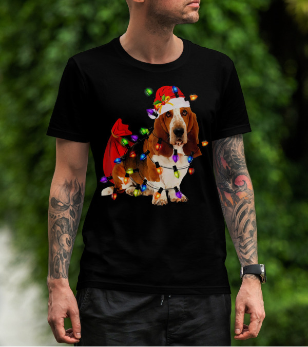 Basset Hound Wrapped In Christmas Lights With Santa Hat And Red Sack T-Shirt