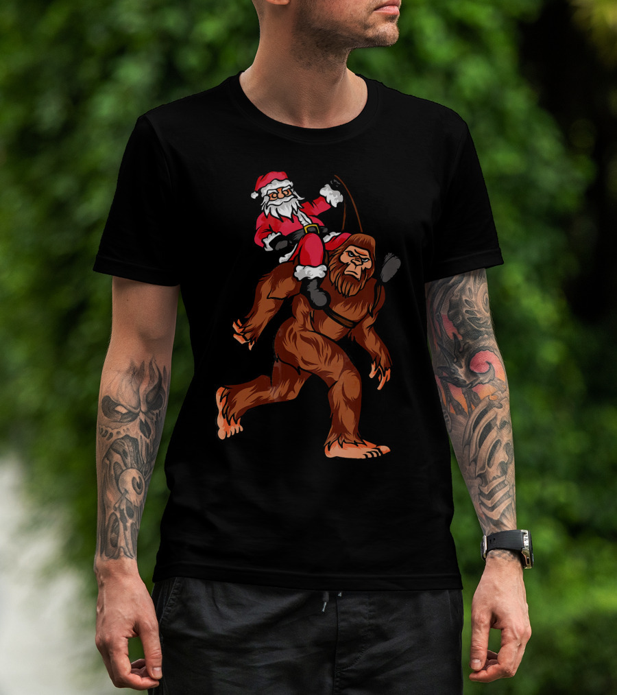 Bigfoot Carrying Santa Claus In Christmas T-Shirt
