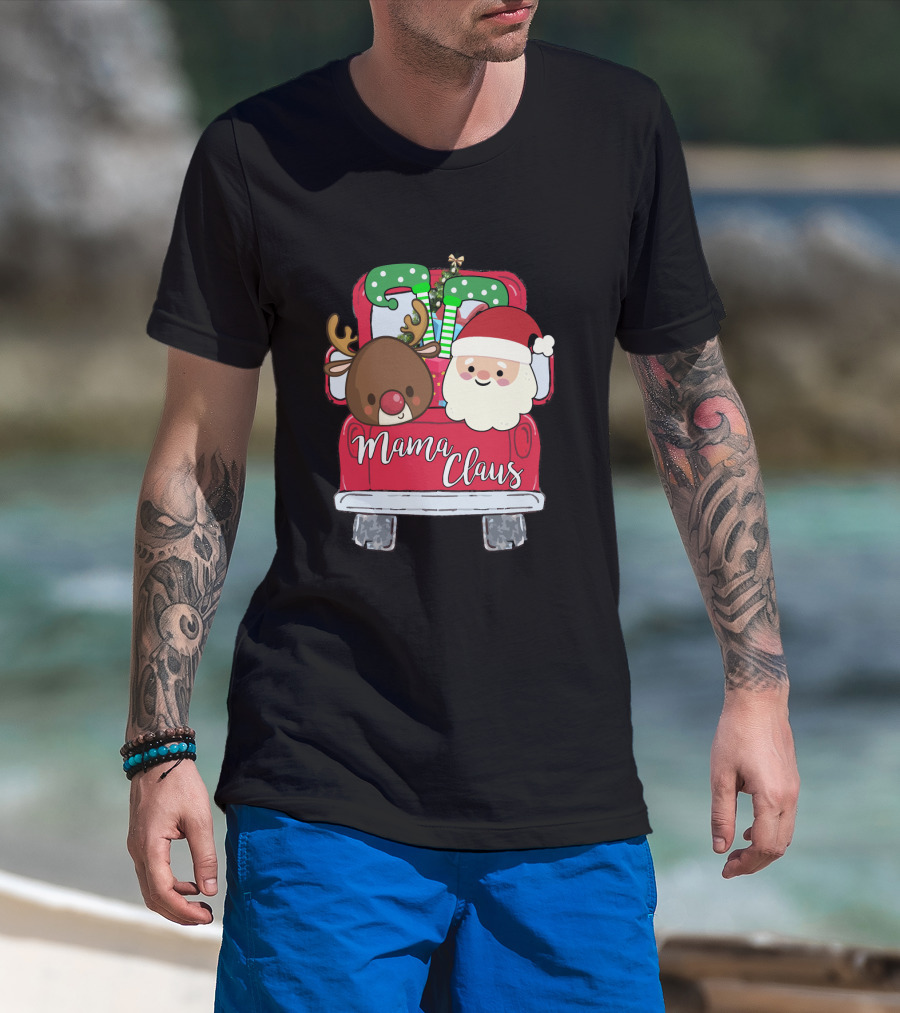 Man with tattoos models Mama Claus Funny Christmas Car With Santa and Reindeer T-Shirt at beach.