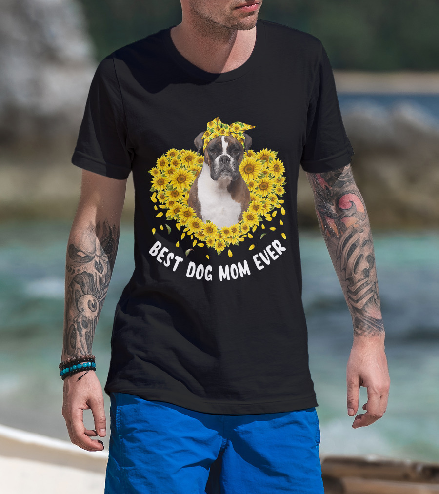 Man with tattoos models Best Dog Mom Ever Boxer Surrounded by Sunflowers T-Shirt at beach.
