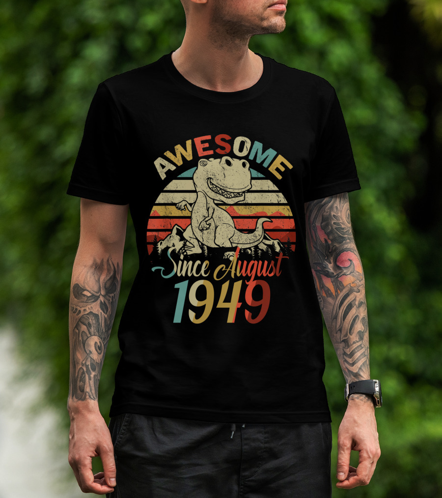 Man with tattoos models Awesome Since August 1949 Vintage Dinosaur Retro T-Shirt outdoors.